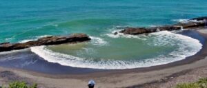 The beach with turquoise water and rocks provides seating areas where you can relax and enjoy the beach