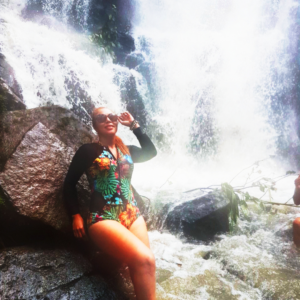 Women posing for a picture in the waterfall 