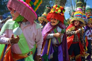 Man in festival suite dancing with colorful outfits