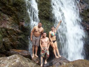 Teen under the waterfall